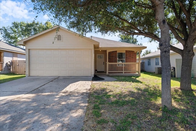 ranch-style house featuring a front lawn, a garage, covered porch, and cooling unit