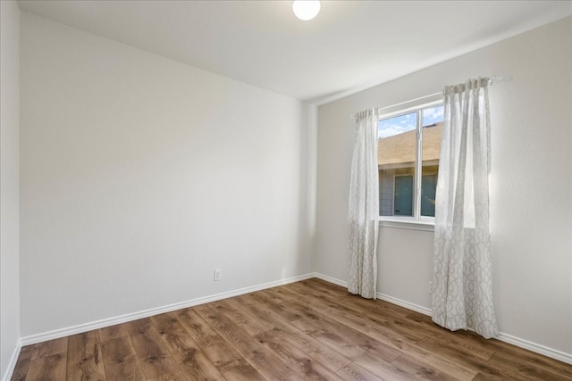 spare room featuring wood-type flooring