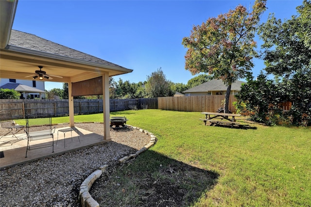 view of yard with ceiling fan and a patio area