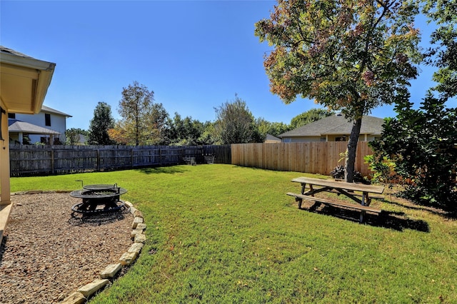 view of yard featuring an outdoor fire pit