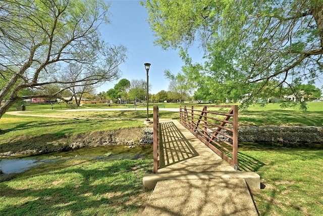 view of community featuring a lawn and a water view