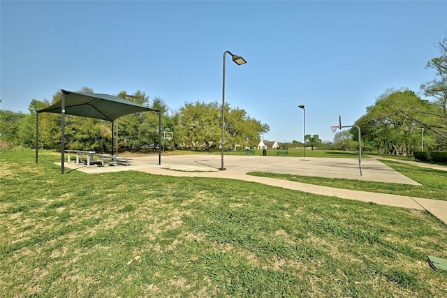 view of property's community with a gazebo, a yard, and basketball court