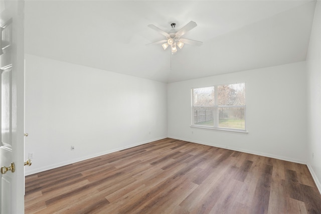 unfurnished room with ceiling fan, lofted ceiling, and hardwood / wood-style flooring