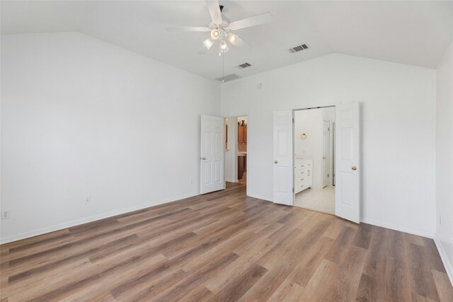 unfurnished bedroom with ceiling fan, hardwood / wood-style floors, and high vaulted ceiling