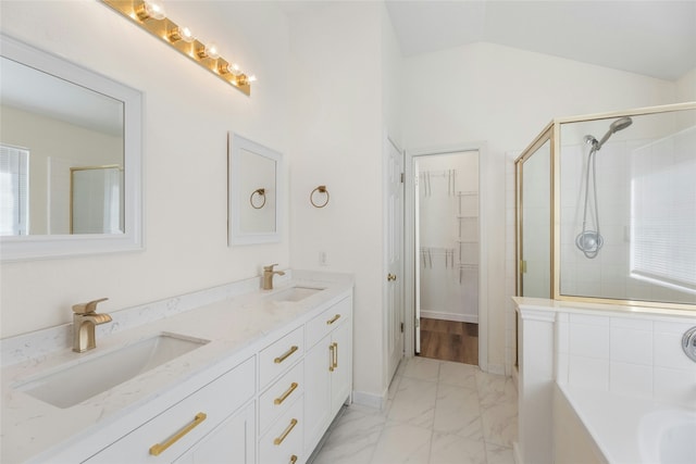 bathroom with vanity, separate shower and tub, and vaulted ceiling