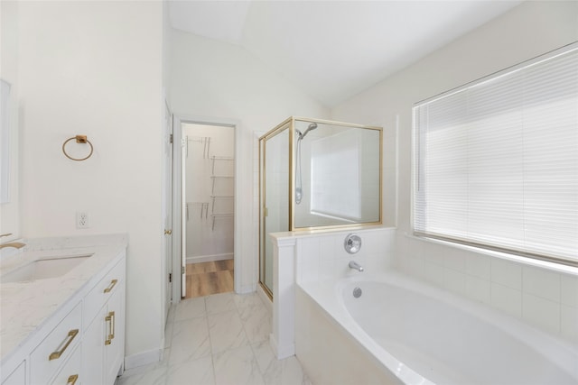 bathroom featuring vanity, separate shower and tub, and vaulted ceiling