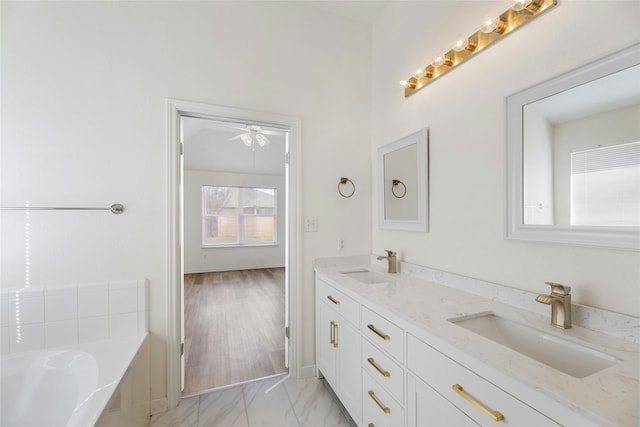 bathroom featuring a washtub and vanity