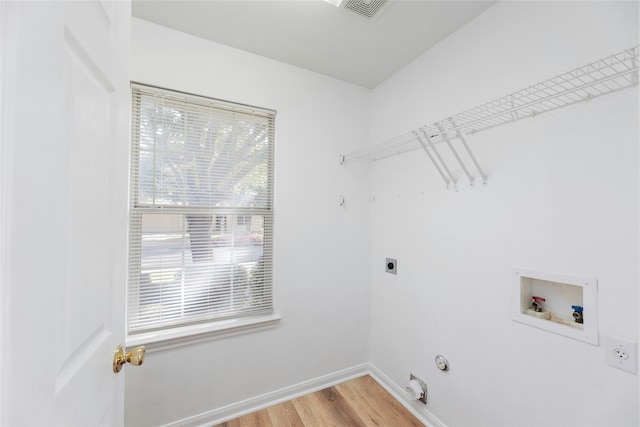 washroom featuring hardwood / wood-style floors, plenty of natural light, hookup for a washing machine, hookup for an electric dryer, and gas dryer hookup