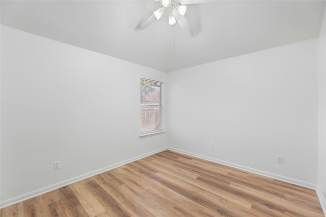 empty room with ceiling fan and light hardwood / wood-style flooring