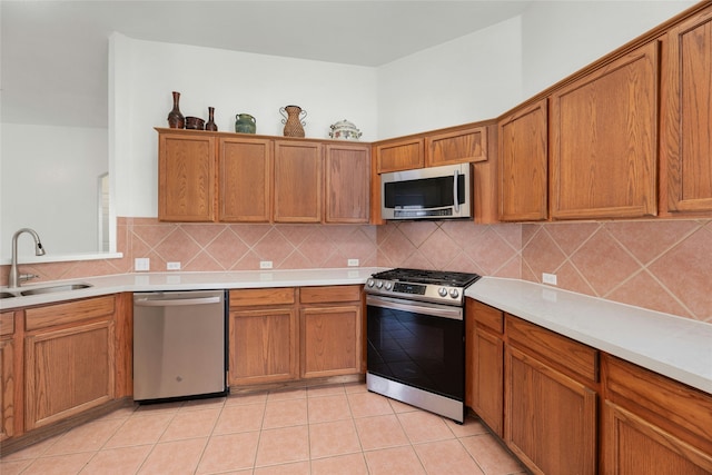 kitchen featuring decorative backsplash, sink, stainless steel appliances, and light tile patterned flooring