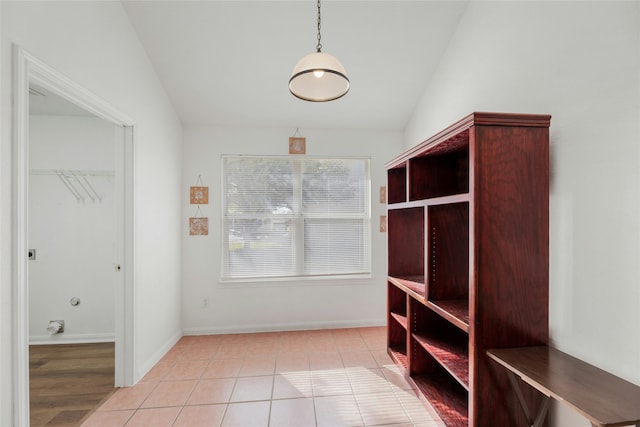 mudroom with light tile patterned floors and lofted ceiling