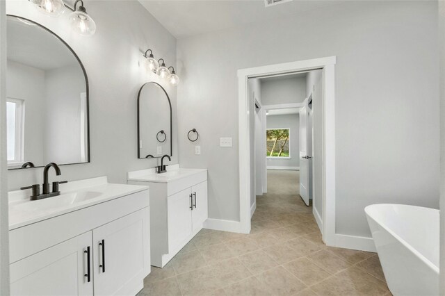 bathroom featuring vanity and a bath