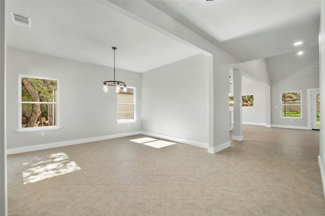 unfurnished room with a chandelier and plenty of natural light