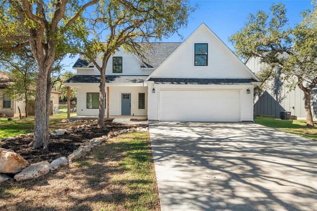 view of front of house featuring central AC unit and a garage