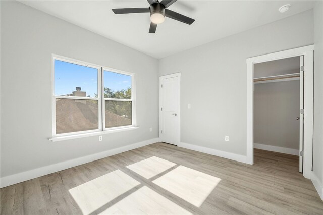 unfurnished bedroom featuring a closet, ceiling fan, and light hardwood / wood-style flooring