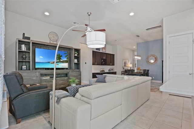 tiled living room with ceiling fan