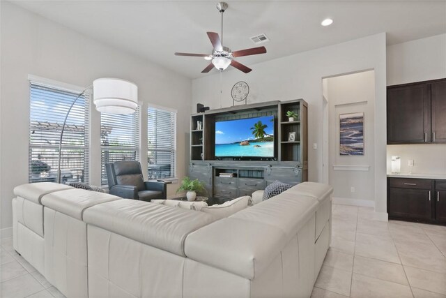 living room featuring ceiling fan and light tile patterned flooring