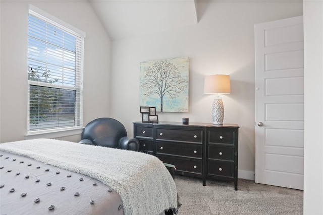 bedroom featuring light carpet and lofted ceiling