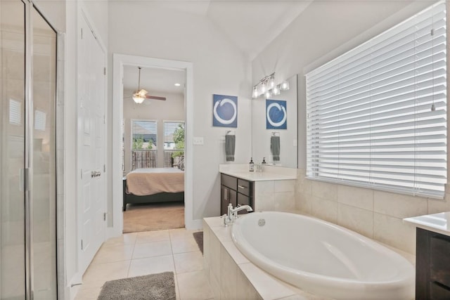 bathroom featuring tile patterned floors, vanity, vaulted ceiling, ceiling fan, and plus walk in shower