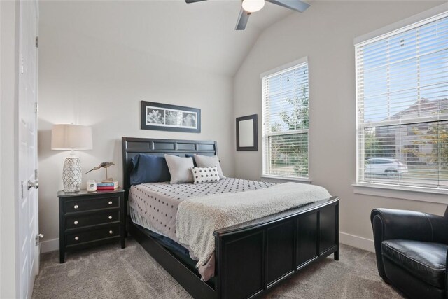 carpeted bedroom featuring ceiling fan and vaulted ceiling