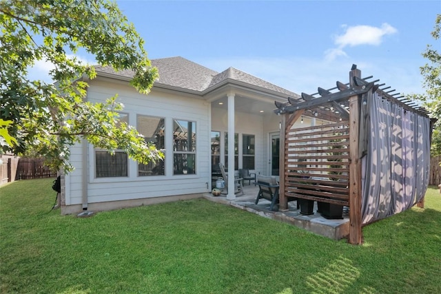 back of house with a pergola, a patio area, and a lawn