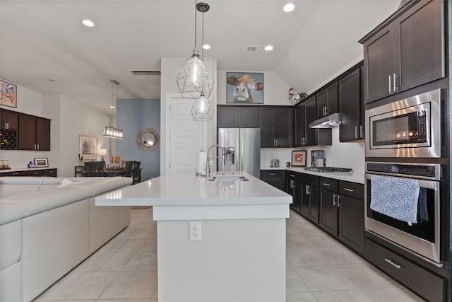 kitchen featuring sink, hanging light fixtures, lofted ceiling, light tile patterned floors, and appliances with stainless steel finishes