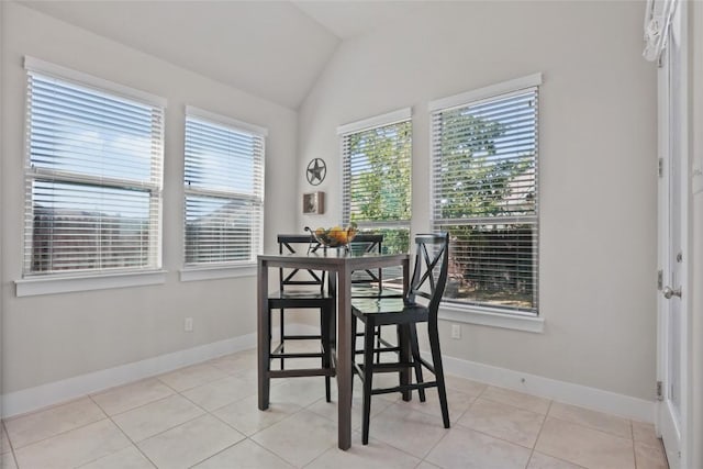 dining area featuring light tile patterned floors and lofted ceiling