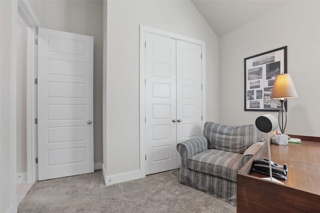 living area with light colored carpet and lofted ceiling