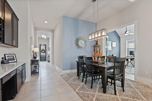 tiled dining area with vaulted ceiling and ceiling fan