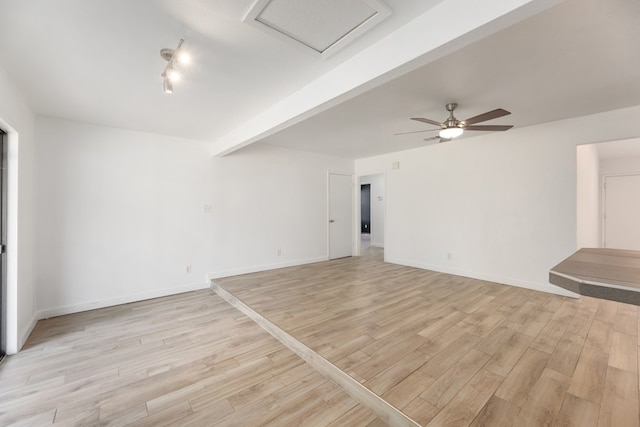 unfurnished living room featuring beam ceiling, light wood-type flooring, and ceiling fan