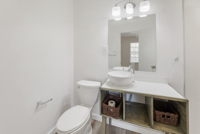 bathroom with vanity, hardwood / wood-style flooring, and toilet