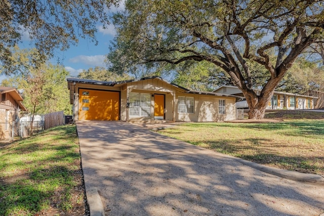 single story home featuring a garage and a front lawn