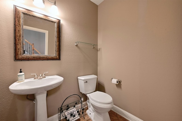 bathroom featuring tile patterned flooring and toilet