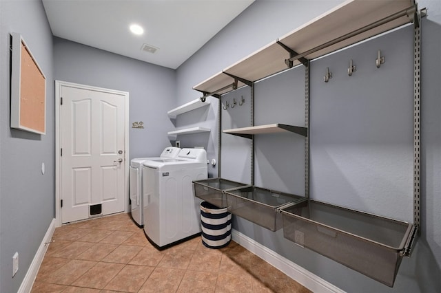 laundry room featuring light tile patterned floors and washing machine and dryer