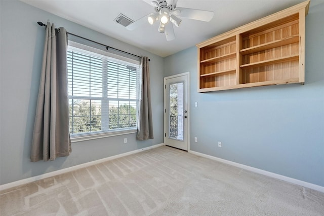 unfurnished room featuring ceiling fan and light colored carpet