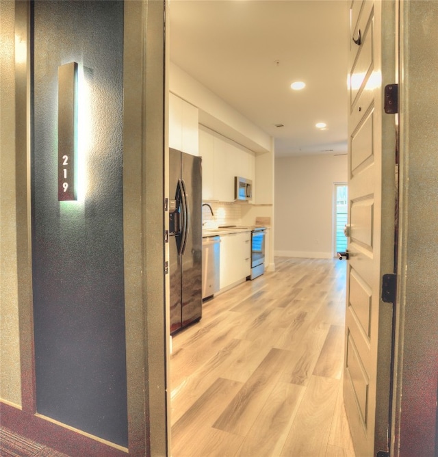 hall featuring light hardwood / wood-style floors