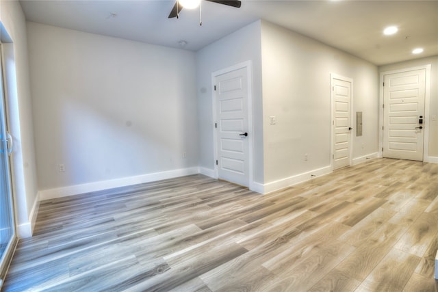 spare room featuring light hardwood / wood-style floors and ceiling fan