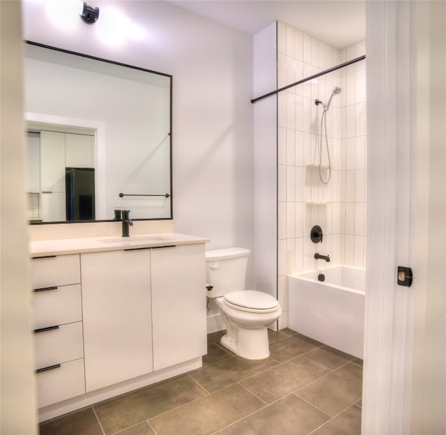 full bathroom featuring tile patterned flooring, vanity, toilet, and tiled shower / bath