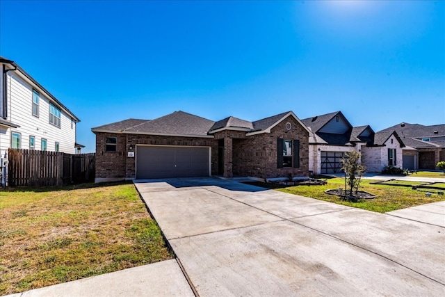 view of front of property with a front yard and a garage