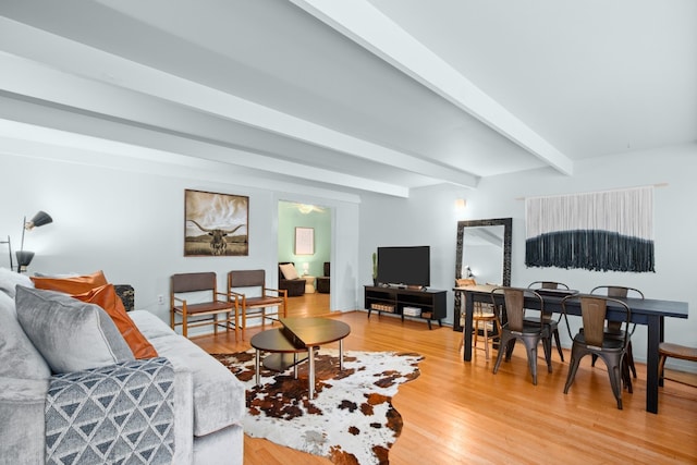 living room with beamed ceiling and hardwood / wood-style floors