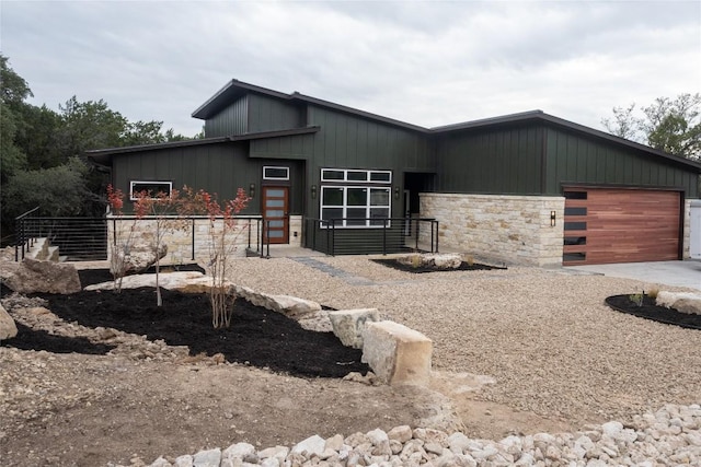 view of front facade featuring a garage and stone siding