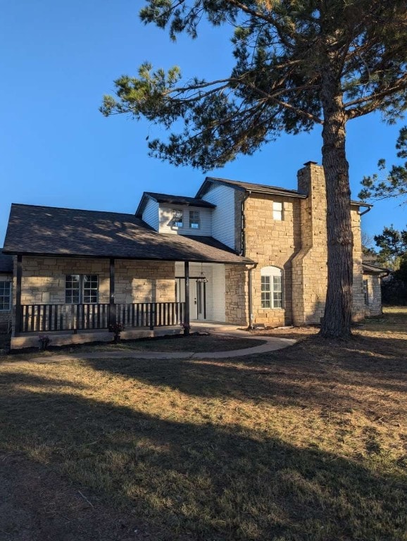 rear view of property featuring a wooden deck and a yard