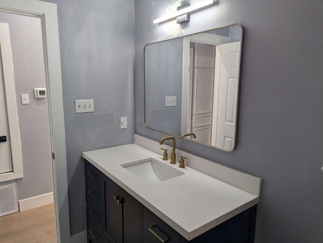 bathroom with vanity and hardwood / wood-style flooring