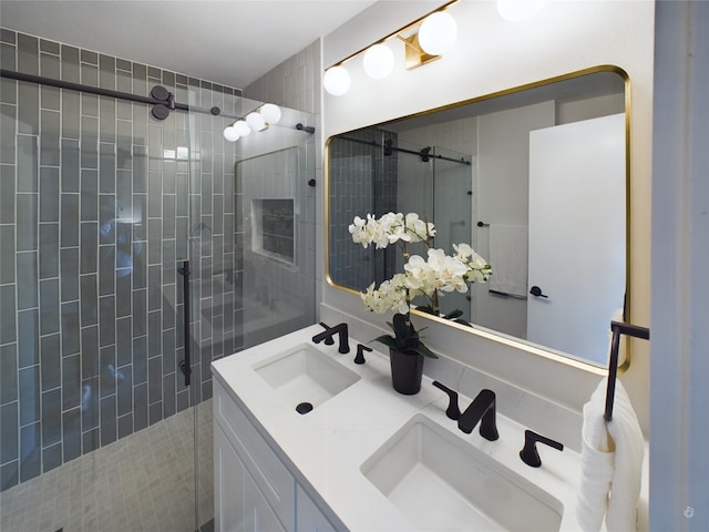 bathroom with vanity and a shower with shower door