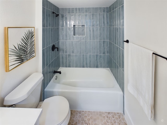 bathroom with tile patterned floors, toilet, and tiled shower / bath