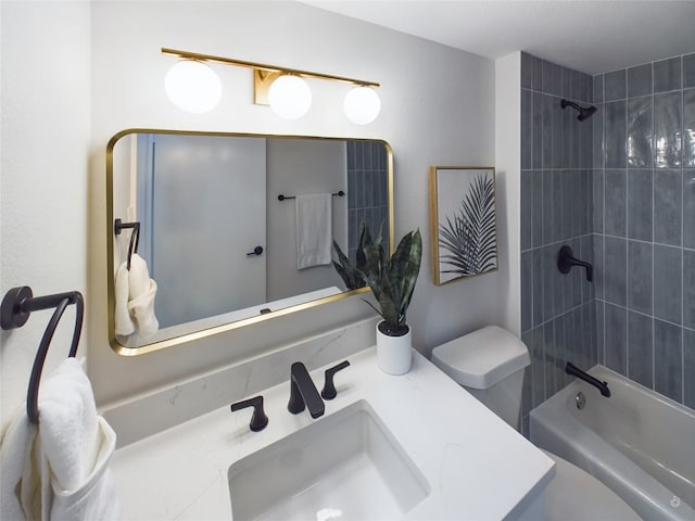 full bathroom with vanity, tiled shower / bath combo, and toilet