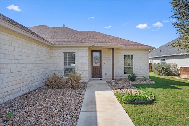 property entrance with a lawn