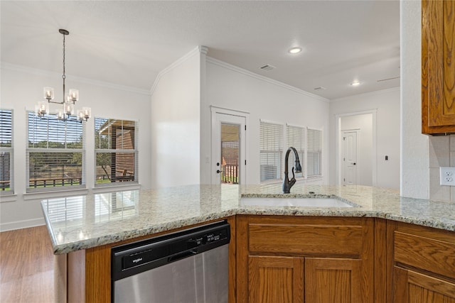 kitchen with dishwasher, sink, an inviting chandelier, light wood-type flooring, and ornamental molding