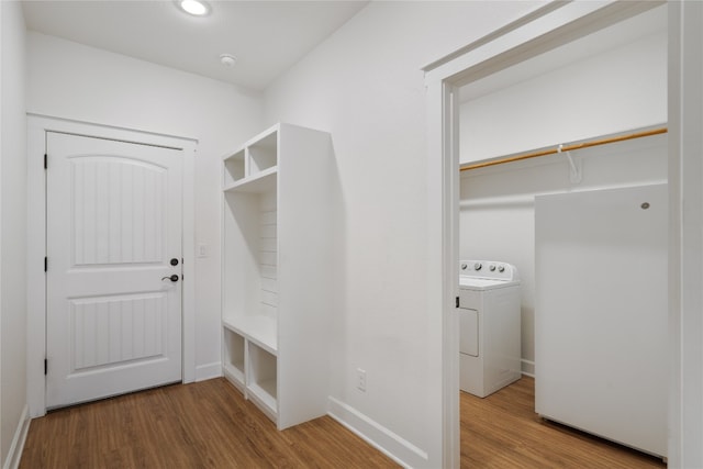 mudroom featuring hardwood / wood-style floors and washer / dryer