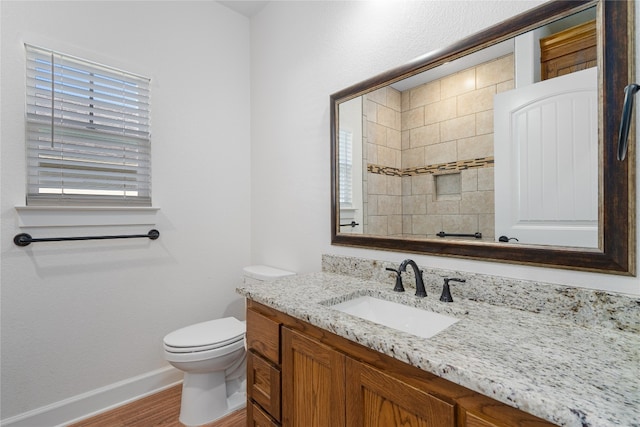 bathroom featuring hardwood / wood-style flooring, vanity, and toilet